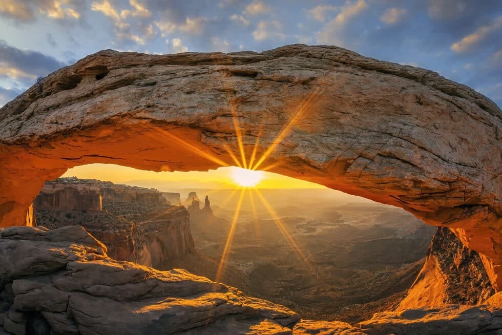 Sunrise through natural rock arch